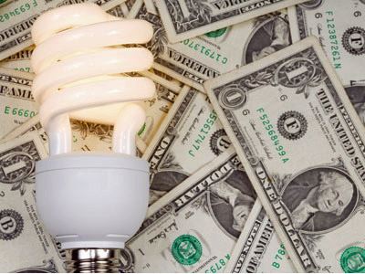 Lightbulb with money in the background