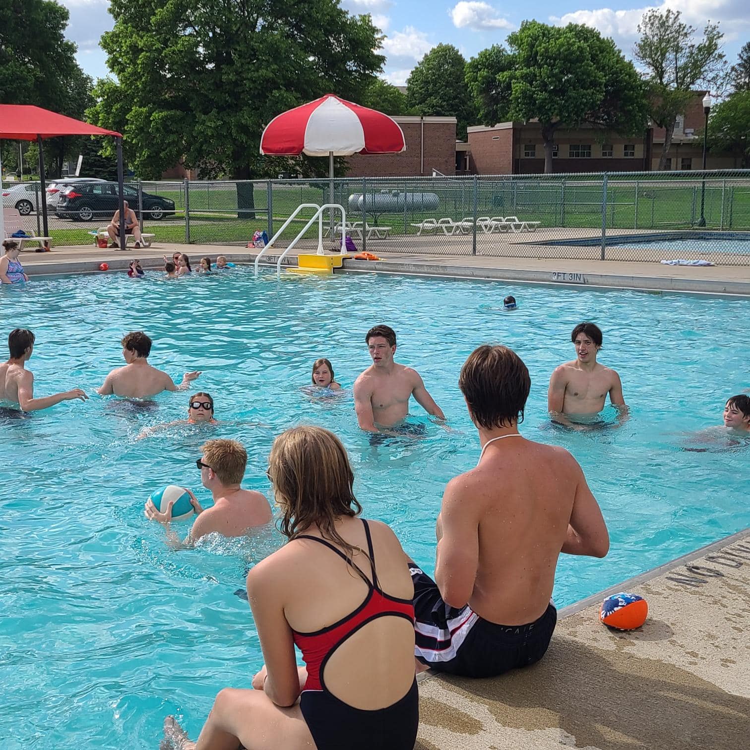 Lifeguards and swimmers in pool