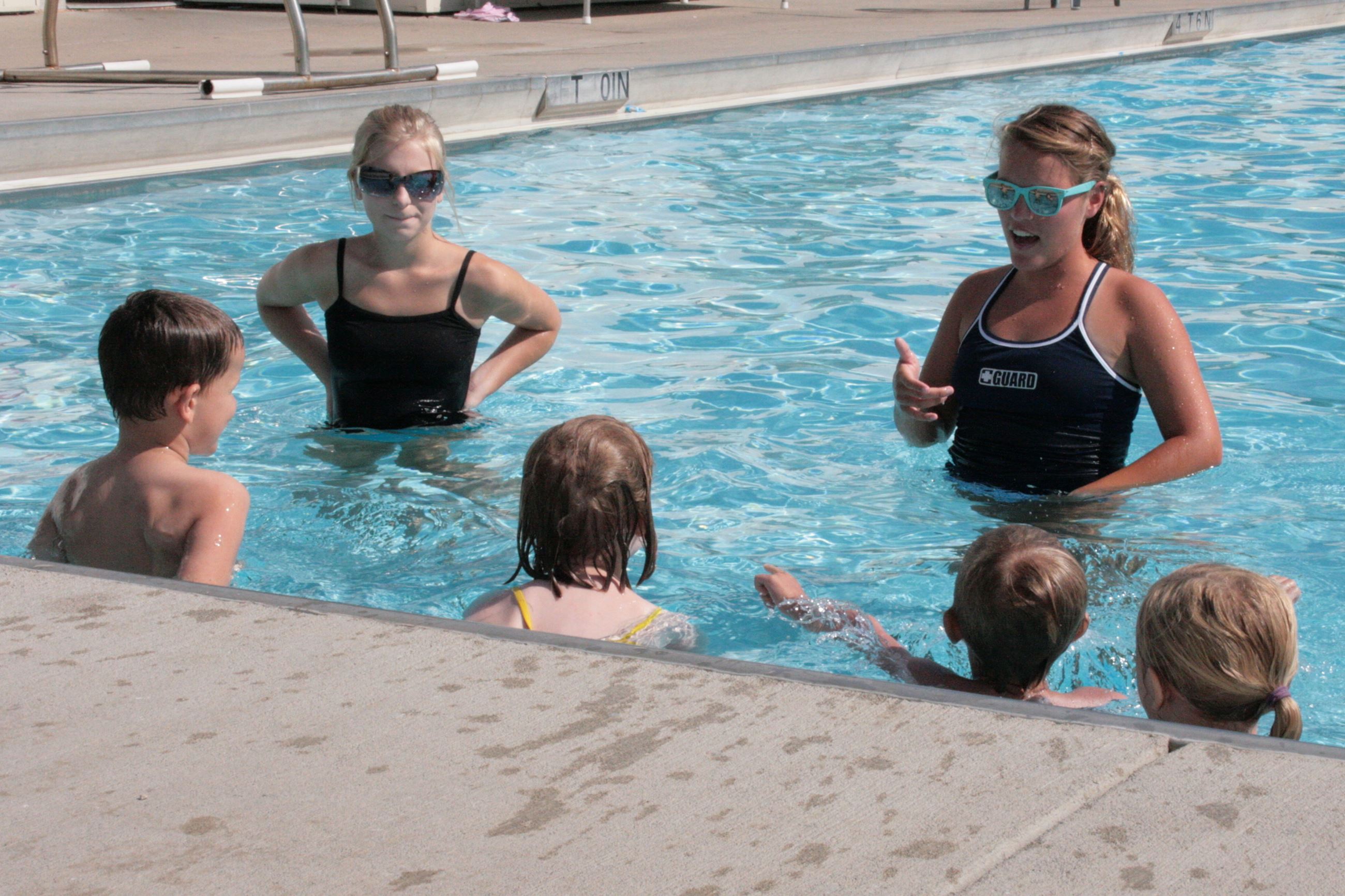 Instructors and swimmers in pool